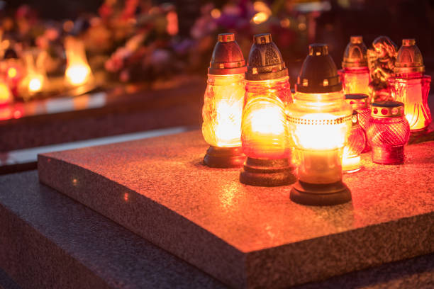 istock graveyard cementary memorial with burning candles 1224041146