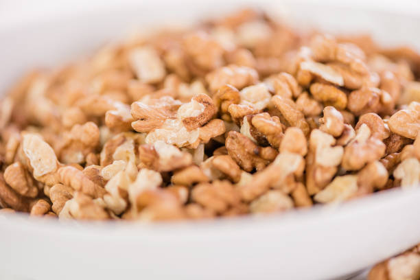 bowl of whole wallnuts on white background