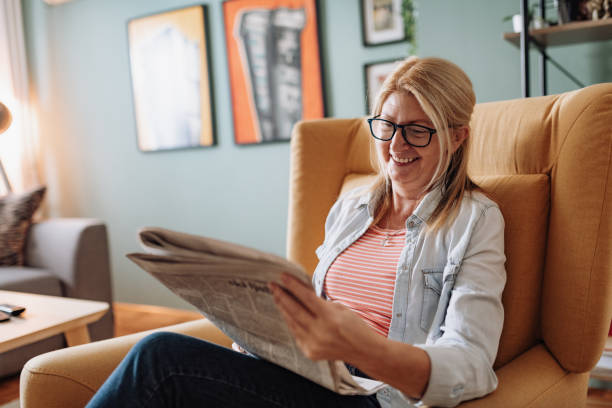 istock Senior woman resting at home and reading newspapers 1224041896