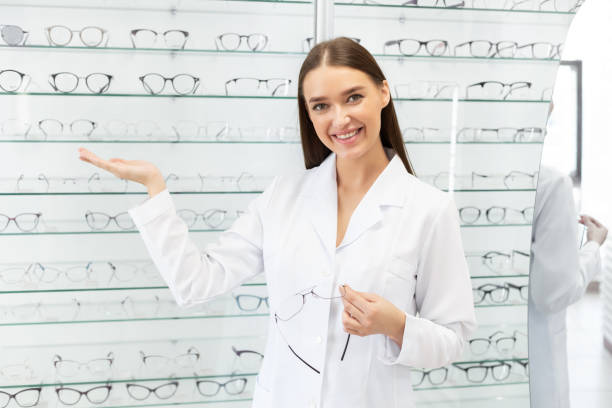 istock Female optometrist helping client to choose glasses 1224042118