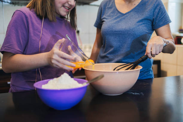 istock Little child makes pancakes with her mum's help 1224042743