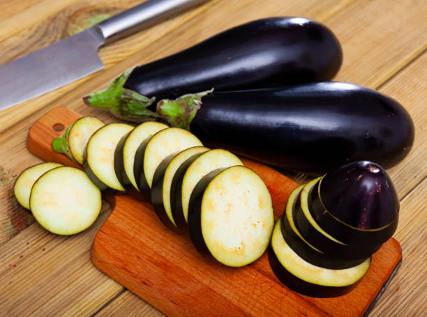 istock Fresh eggplants sliced on wooden desk in kitchen 1224043428
