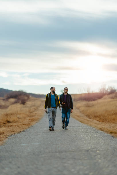 istock Friends hiking down the road 1224043685