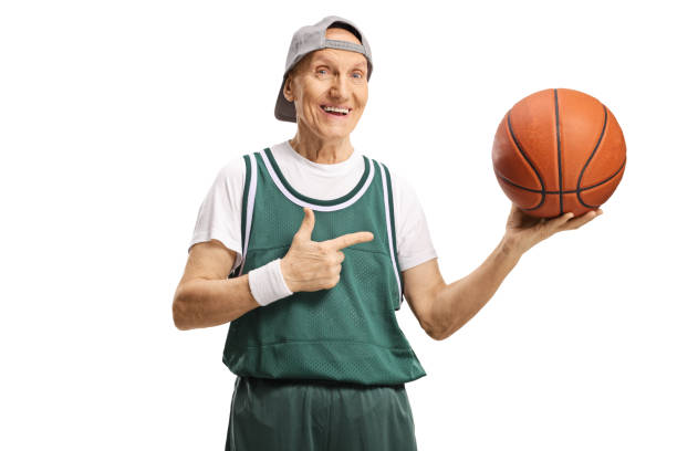 istock Cheerful elderly man holding a basketball and pointing 1224043864