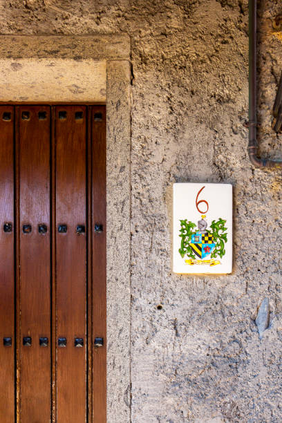Bomarzo, Italy old architecture Bomarzo, Italy - June 02 2018: Nobile Rione Dentro house numbering in Bomarzo, Province of Viterbo, Lazio, Italy. House door with the number six ceramic tile house numbers stock pictures, royalty-free photos & images