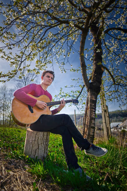 istock Young guitarist outdoor 1224044561
