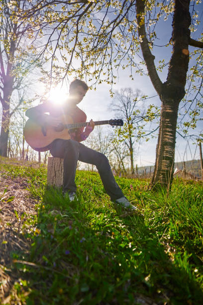 istock Young guitarist outdoor 1224044563