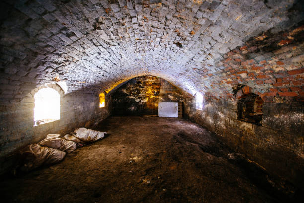 Abandoned empty old dark underground vaulted cellar Abandoned empty old dark underground vaulted cellar. dungeon medieval prison prison cell stock pictures, royalty-free photos & images
