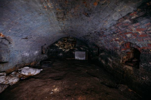 Abandoned empty old dark underground vaulted cellar Abandoned empty old dark underground vaulted cellar. dungeon medieval prison prison cell stock pictures, royalty-free photos & images