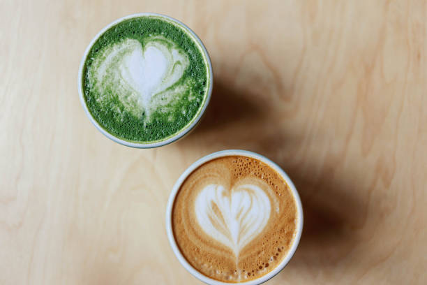 couple of cups with coffee and matcha tea stock photo
