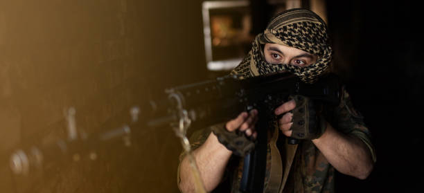 arab male soldier in a headdress from the national keffiyeh with weapons in his hands. muslim with firearms - jihad imagens e fotografias de stock