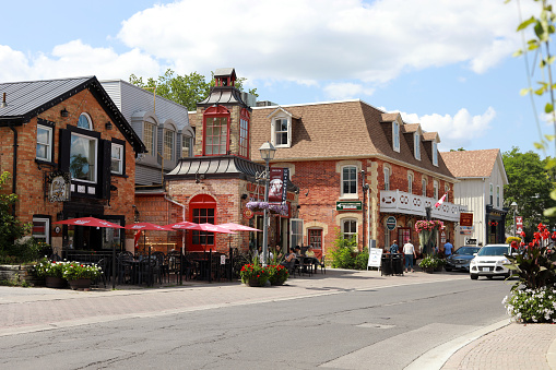 July 24, 2019 - Unionville, Ontario, Canada: Beautiful Main Street of Unionville (Markham) Ontario, Canada on a sunny hot day in July 2019 with nicely decorated stores, cafes and restaurants and people enjoying summer weather. Ontario prettiest towns in summer. Travelling in Ontario, Canada. Tourism in Ontario.