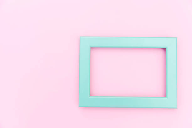 istock Simply design with empty blue frame isolated on pink pastel colorful background. Top view, flat lay, copy space, mock up. Minimal concept 1224050766