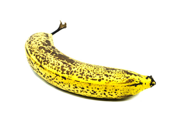istock Yellow Banana with black Spots isolated on white Background 1224052341