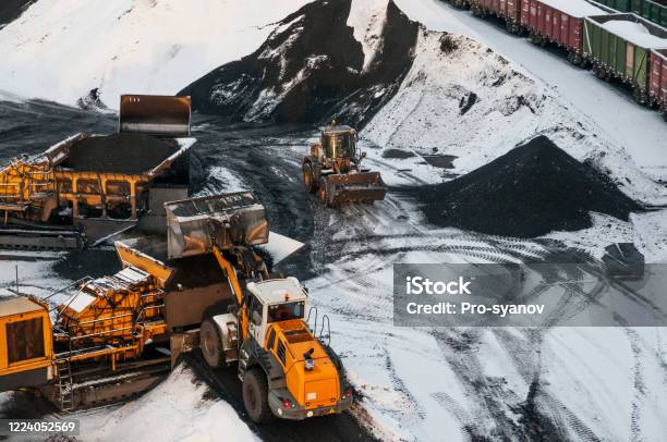 Frontend Loader Loads Coal Onto A Conveyor Belt Stock Photo - Download Image Now - Machinery, Heavy, Winter