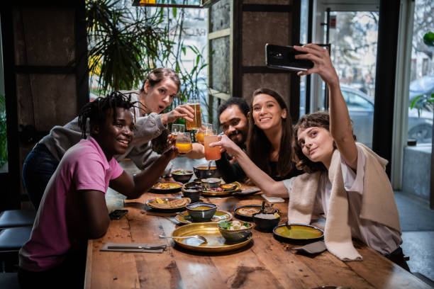 istock Friends sit in a cafe, they talk to the camera having a video ca 1224053296
