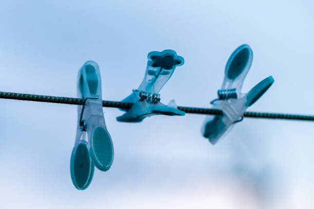 clothes are dried on the wind on background blue sky with clouds. T-shirts hanging on a clothesline