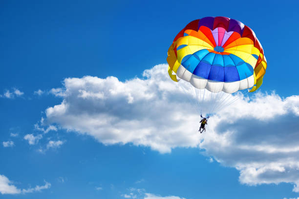 istock A parachute on the background of cloudy blue sky. 1224057115