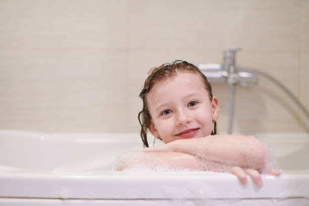 istock little girl in bath playing with soap foam 1224058024