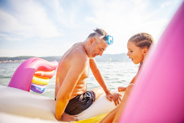 istock Father and Daughter Using Pool Raft on Summer Vacations 1224058111