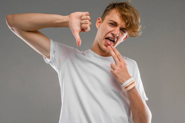istock Young caucasian man in white t-shirt posing and gesticulating on camera isolated on grey background 1224061452