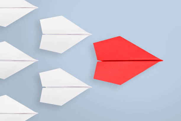 istock Leadership concepts with red paper airplane leading among white 1224063984