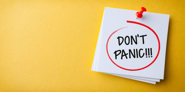 istock White Sticky Note With Don't Panic And Red Push Pin On Yellow Background 1224064697