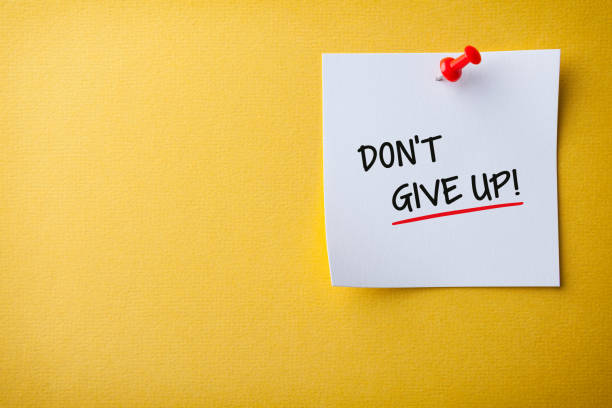 istock White Sticky Note With Don't Give Up And Red Push Pin On Yellow Background 1224064755