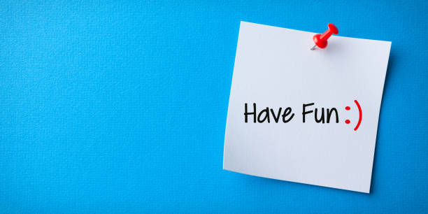 istock White Sticky Note With Have Fun And Red Push Pin On Blue Background 1224064879