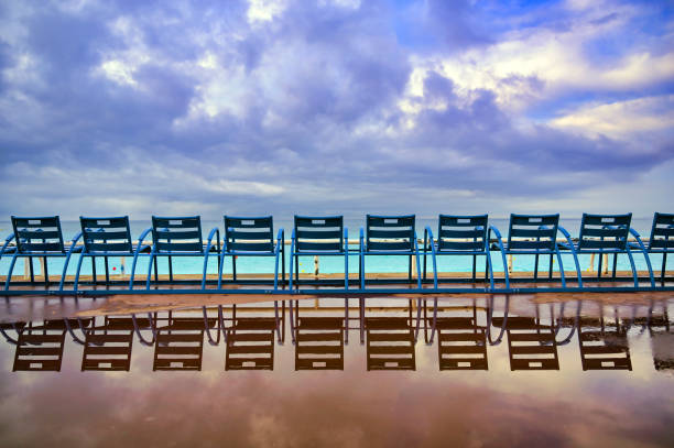 blue chairs along the promenade des anglais at nice, france - city of nice france beach panoramic imagens e fotografias de stock