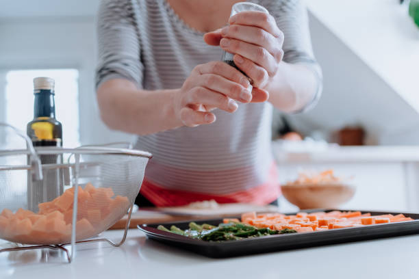 Woman slicing fresh vegetables at home