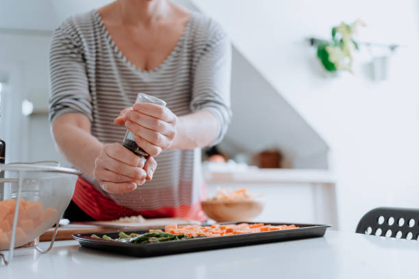 Woman slicing fresh vegetables at home