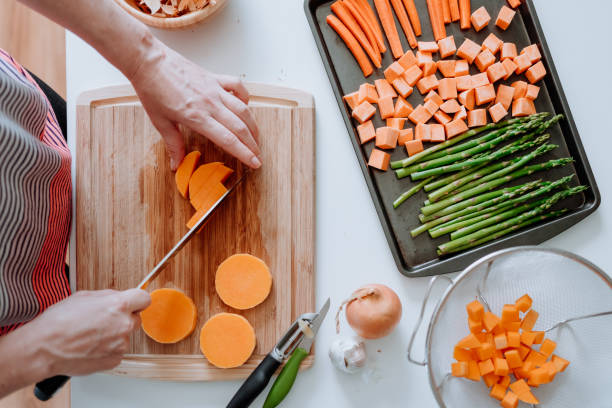 istock Woman slicing fresh vegetables at home 1224068463