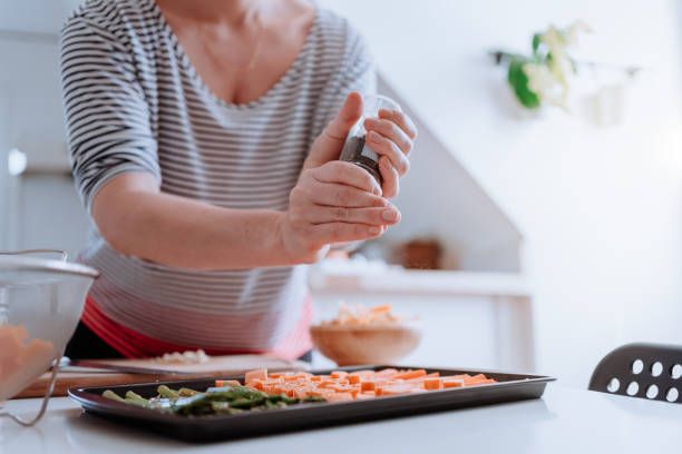Woman slicing fresh vegetables at home