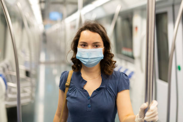 istock Travelers in protective equipment in a subway carriage 1224074233