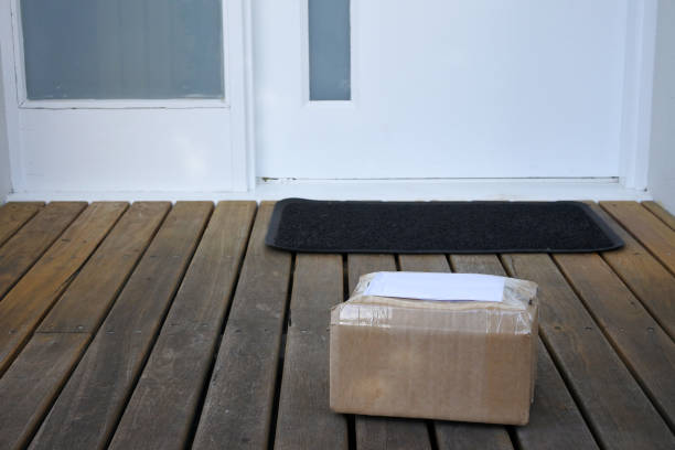istock Package postal box courier delivery on home doorstep 1224075610