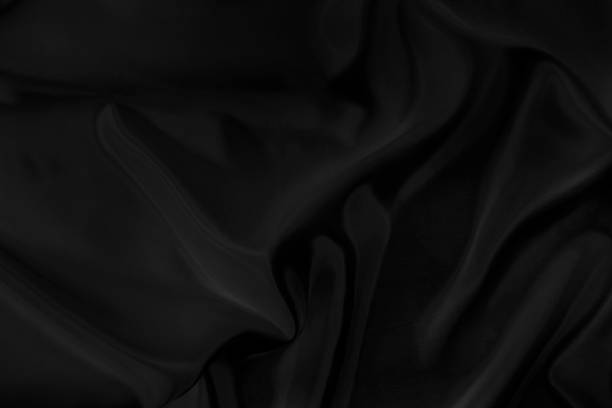 istock Black gray satin dark fabric texture luxurious shiny that is abstract silk cloth background with patterns soft waves blur beautiful. 1224075661