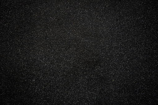 Suelo de asfalto negro o fondo de textura de carretera. Fondo negro de textura de suelo de piedra pequeña. photo