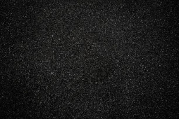 Photo of Black asphalt floor or road texture background. Black small stone floor texture background.