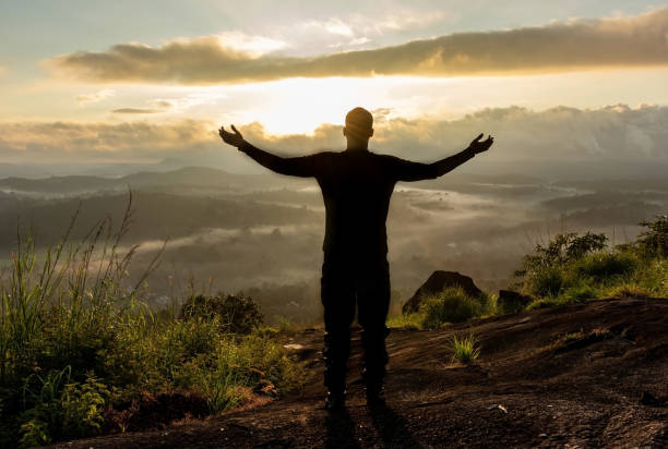 istock man backlight soaking the amazing view of mountain layers covered with white mist at dawn 1224078040