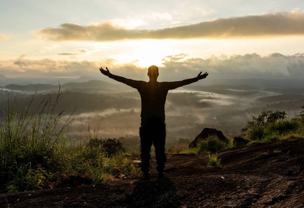 istock man backlight soaking the amazing view of mountain layers covered with white mist at dawn 1224078041