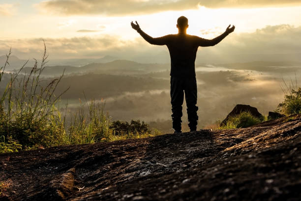 istock man backlight soaking the amazing view of mountain layers covered with white mist at dawn 1224078076