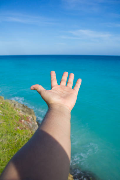 istock man hand and tropical beach 1224078249