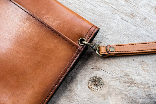 istock Close up brown leather wallet on wood texture. 1224078266