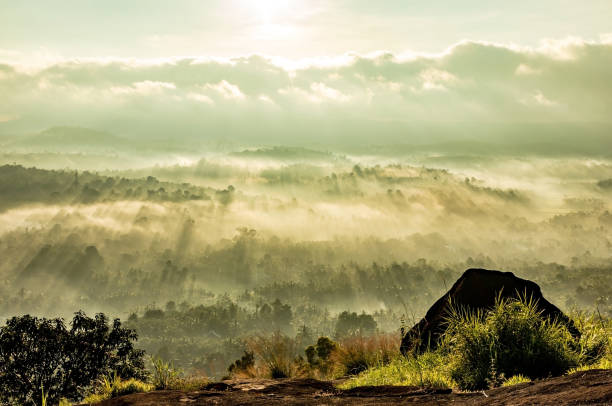 istock mountain layers covered with white mist and orange sun rays at dawn 1224078304