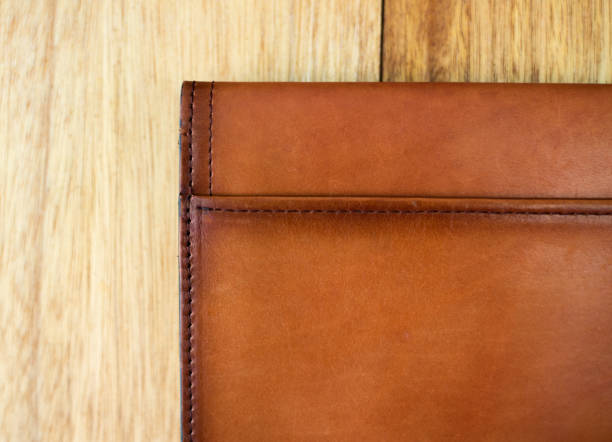 istock Close up brown leather wallet on wood texture. 1224078346