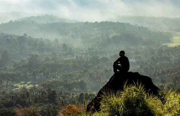 istock man backlight soaking the amazing view of mountain layers covered with white mist at dawn 1224079098