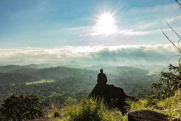 istock man backlight soaking the amazing view of mountain layers covered with white mist at dawn 1224079161
