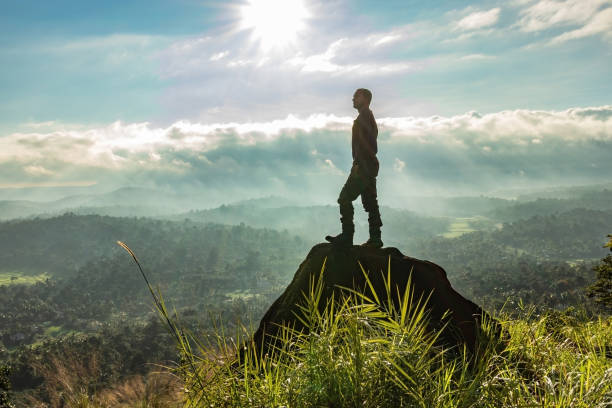 istock man backlight soaking the amazing view of mountain layers covered with white mist at dawn 1224079272