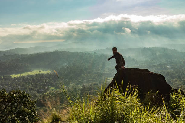istock man backlight soaking the amazing view of mountain layers covered with white mist at dawn 1224079286